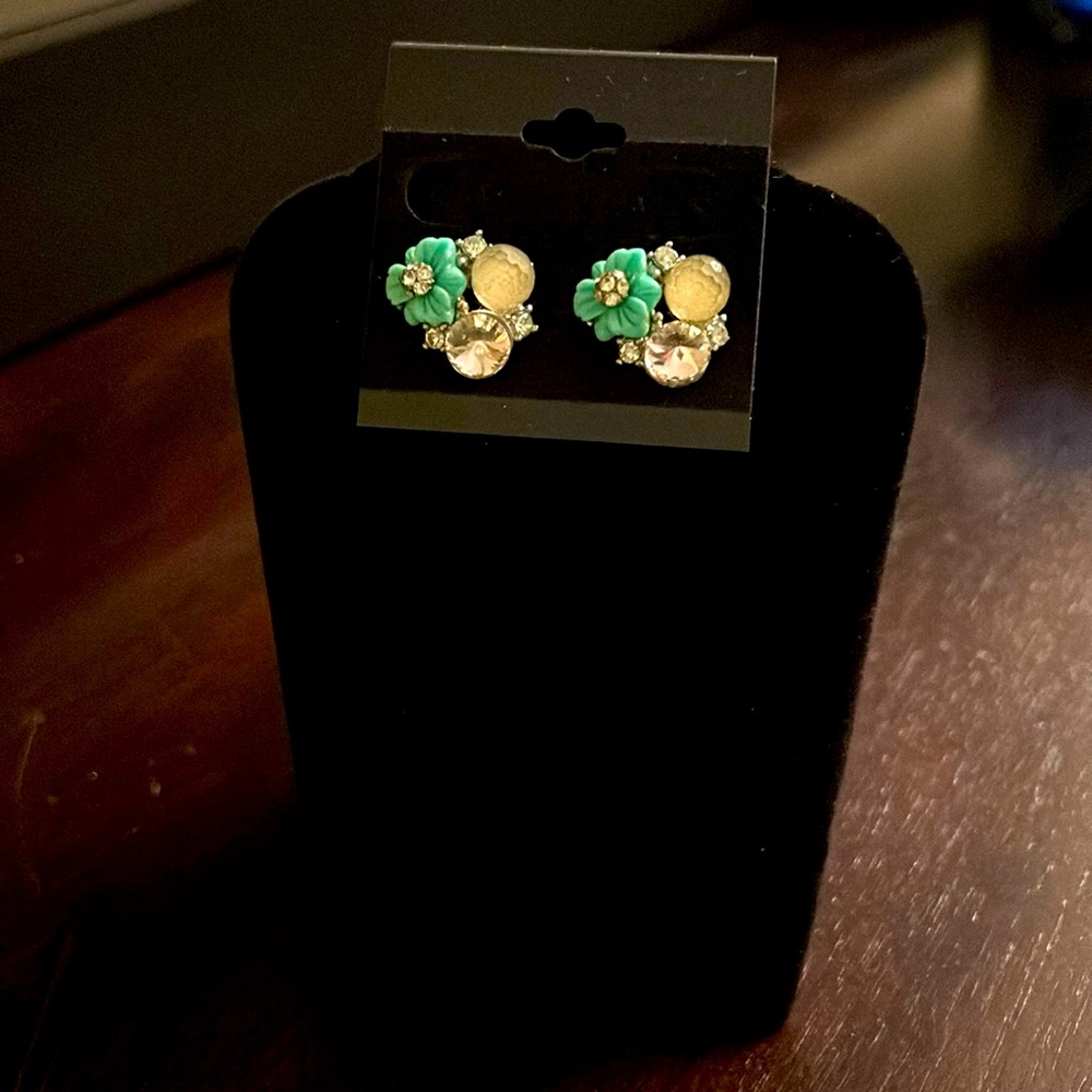 Teal and clear gems on a silver tone post.